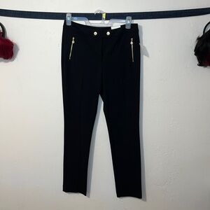 Anne Klein black trousers with gold zipper slant pockets and gold snap waist.
